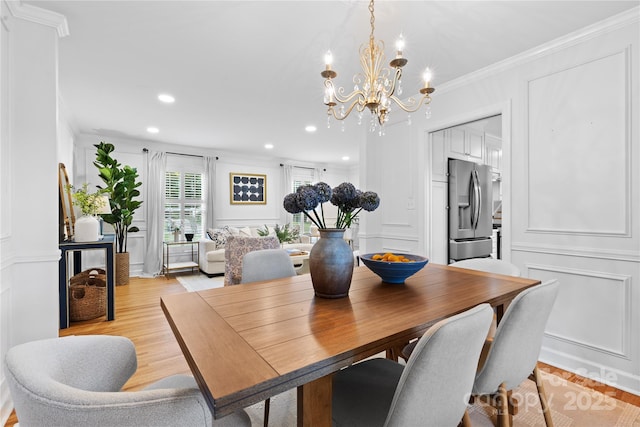 1024 Regency Dr, Charlotte, NC 28211 - dining area featuring a decorative wall, a chandelier, ornamental molding, recessed lighting, and light wood finished floors