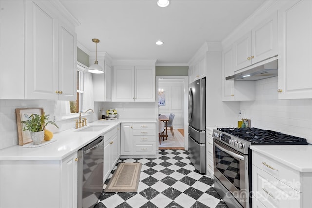 1024 Regency Dr, Charlotte, NC 28211 - kitchen featuring stainless steel appliances, under cabinet range hood, white cabinets, light floors, and decorative light fixtures