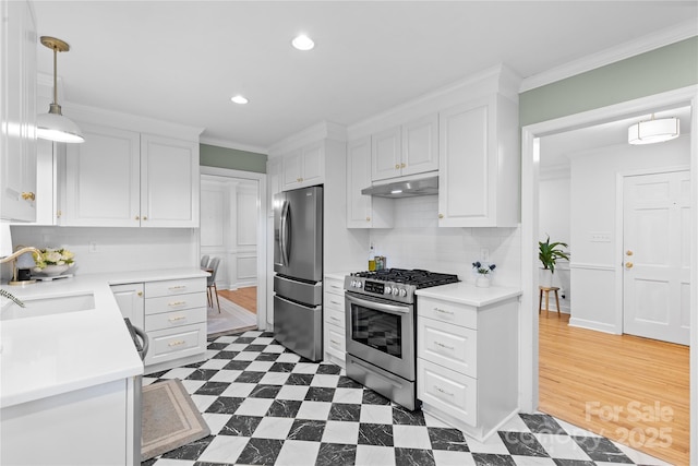 1024 Regency Dr, Charlotte, NC 28211 - kitchen featuring stainless steel appliances, under cabinet range hood, white cabinetry, tasteful backsplash, and crown molding
