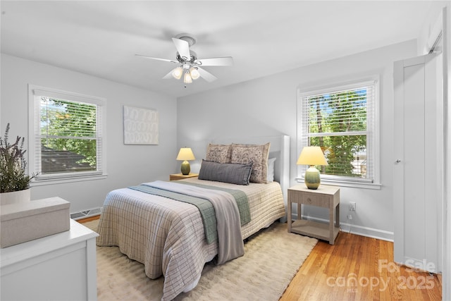 1024 Regency Dr, Charlotte, NC 28211 - bedroom with multiple windows, light wood-style flooring, and ceiling fan