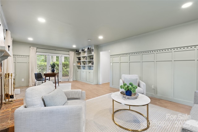 1024 Regency Dr, Charlotte, NC 28211 - living room with a decorative wall, ornamental molding, light wood-style flooring, and recessed lighting