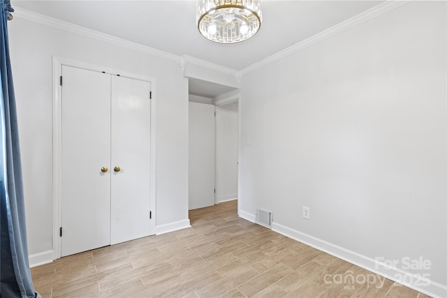 1024 Regency Dr, Charlotte, NC 28211 - unfurnished bedroom with a chandelier, ornamental molding, and light wood-style flooring
