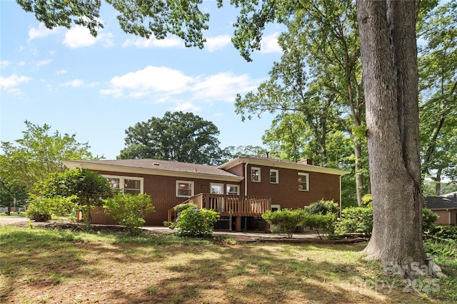 1024 Regency Dr, Charlotte, NC 28211 - back of house featuring a wooden deck, a chimney, a lawn, and brick siding