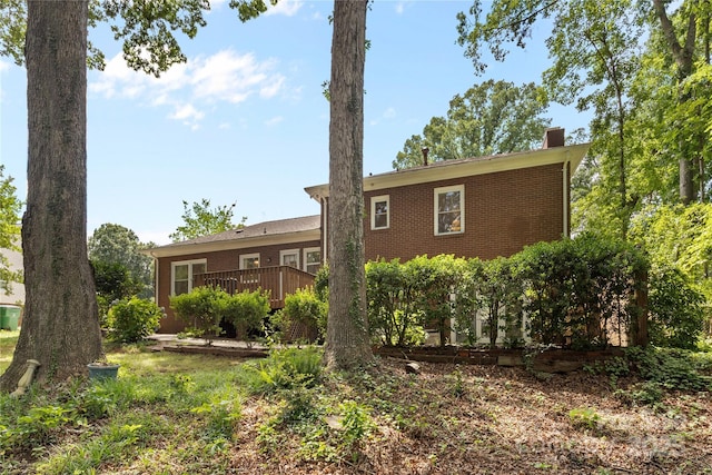1024 Regency Dr, Charlotte, NC 28211 - back of property with a wooden deck, a chimney, and brick siding