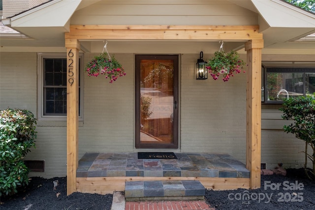 6259 River Cabin Ln, Charlotte, NC 28278 - view of exterior entry with a porch, crawl space, and brick siding
