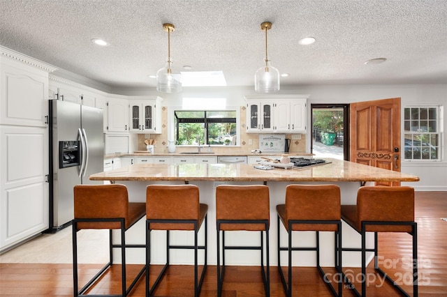 6259 River Cabin Ln, Charlotte, NC 28278 - kitchen with appliances with stainless steel finishes, a textured ceiling, glass insert cabinets, white cabinetry, and recessed lighting