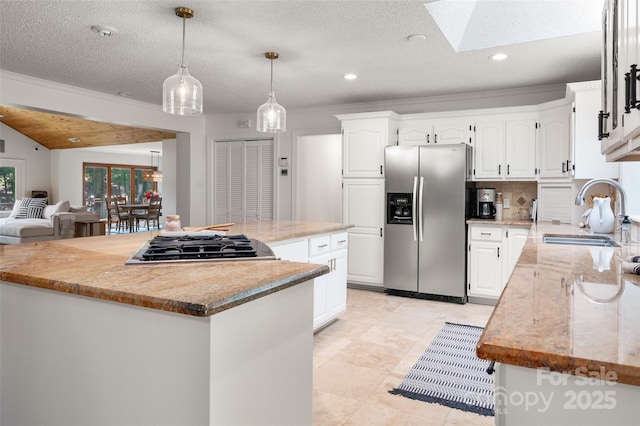 6259 River Cabin Ln, Charlotte, NC 28278 - kitchen featuring stainless steel appliances, a center island, a skylight, decorative backsplash, and ornamental molding