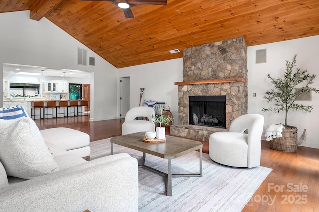 6259 River Cabin Ln, Charlotte, NC 28278 - living room featuring wood finished floors, high vaulted ceiling, a ceiling fan, a stone fireplace, and a wood ceiling with exposed beams