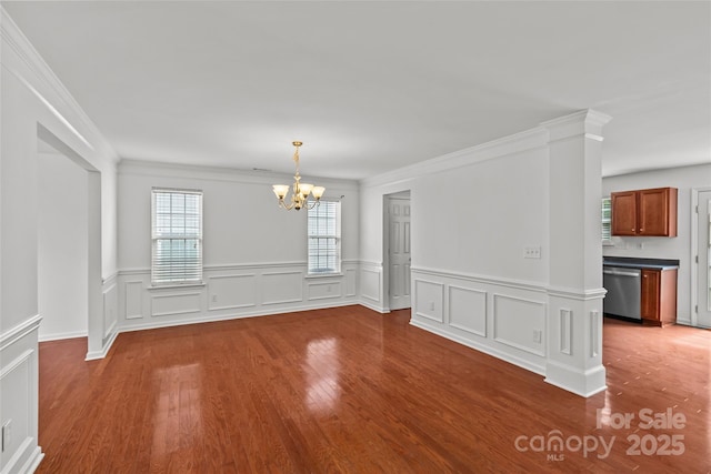 516 Cool Creek Dr, Rock Hill, SC 29732 - unfurnished dining area with a chandelier, wood finished floors, a wainscoted wall, ornamental molding, and a decorative wall