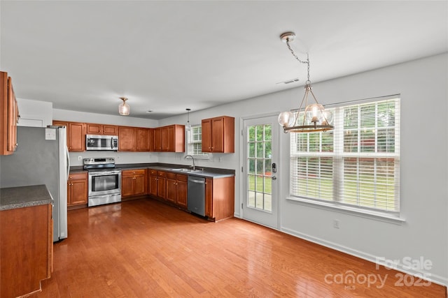 516 Cool Creek Dr, Rock Hill, SC 29732 - kitchen featuring appliances with stainless steel finishes, dark countertops, wood finished floors, and brown cabinetry