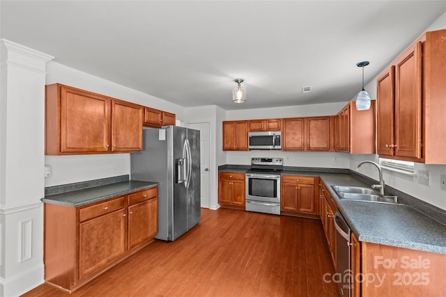 516 Cool Creek Dr, Rock Hill, SC 29732 - kitchen with stainless steel appliances, dark wood finished floors, dark countertops, and brown cabinetry