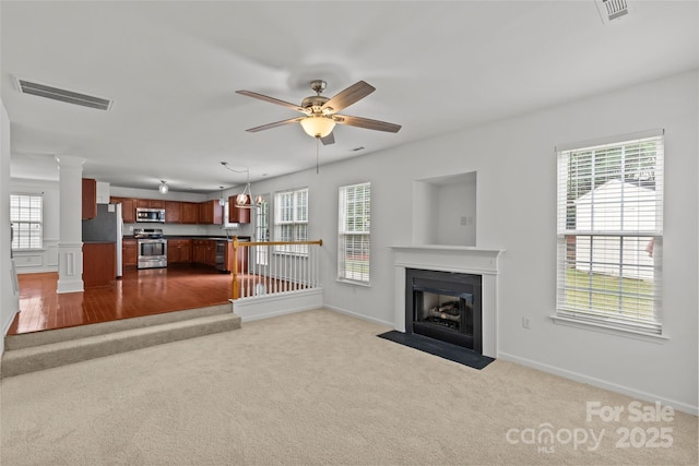 516 Cool Creek Dr, Rock Hill, SC 29732 - unfurnished living room with dark colored carpet, a fireplace with flush hearth, ornate columns, and a ceiling fan