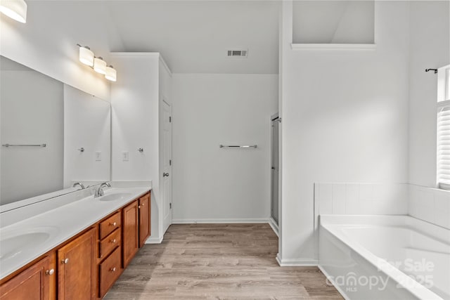 516 Cool Creek Dr, Rock Hill, SC 29732 - bathroom featuring a bath, double vanity, wood finished floors, and a stall shower