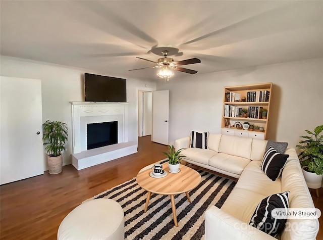 7812 Old Concord Rd, Salisbury, NC 28146 - living area with wood finished floors, a ceiling fan, and a fireplace with raised hearth