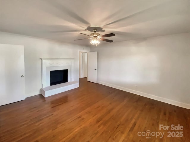 7812 Old Concord Rd, Salisbury, NC 28146 - unfurnished living room with dark wood-style flooring, ceiling fan, and a fireplace with raised hearth