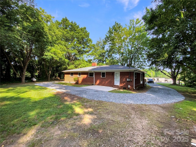 7812 Old Concord Rd, Salisbury, NC 28146 - view of front of house with brick siding, driveway, a chimney, and a front yard