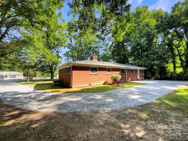 7812 Old Concord Rd, Salisbury, NC 28146 - ranch-style house featuring brick siding, a chimney, gravel driveway, and a front yard