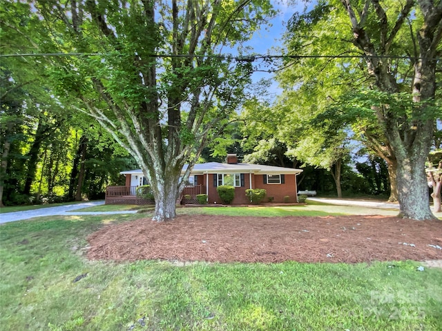 7812 Old Concord Rd, Salisbury, NC 28146 - ranch-style home featuring a chimney, brick siding, and a front yard