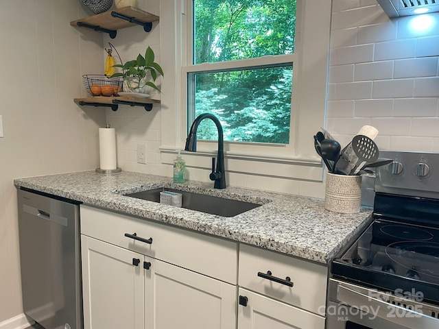 107 Byrd St, Morganton, NC 28655 - kitchen with stainless steel appliances, open shelves, light stone counters, and white cabinets