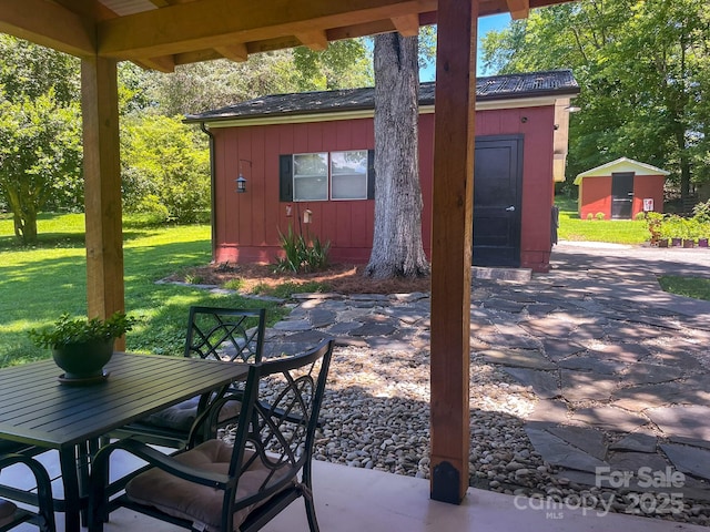 107 Byrd St, Morganton, NC 28655 - view of patio featuring a storage shed and outdoor dining area