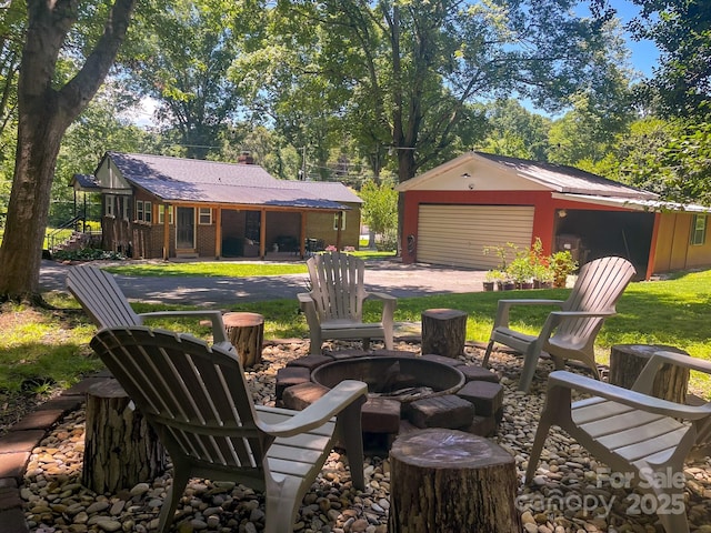 107 Byrd St, Morganton, NC 28655 - view of yard with an outdoor fire pit, a garage, and an outdoor structure