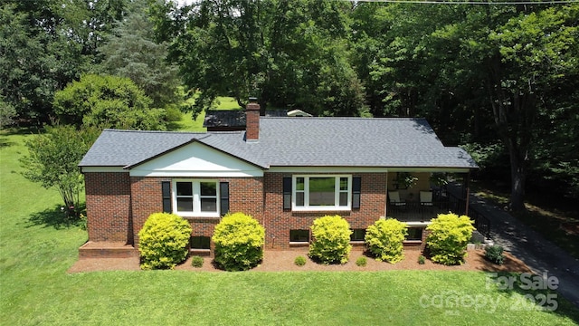 107 Byrd St, Morganton, NC 28655 - view of front of house with a front lawn, brick siding, a chimney, and a shingled roof