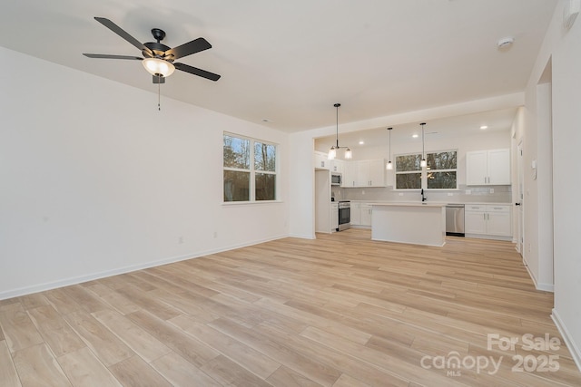 318 Sixth St, Belmont, NC 28012 - unfurnished living room with light wood-type flooring, a ceiling fan, and recessed lighting