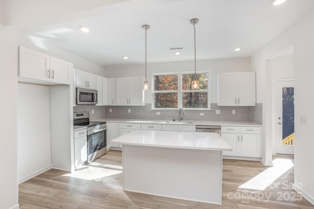 318 Sixth St, Belmont, NC 28012 - kitchen featuring stainless steel appliances, light countertops, tasteful backsplash, white cabinetry, and recessed lighting