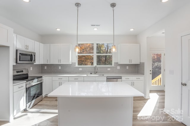 318 Sixth St, Belmont, NC 28012 - kitchen with appliances with stainless steel finishes, backsplash, light countertops, white cabinets, and recessed lighting