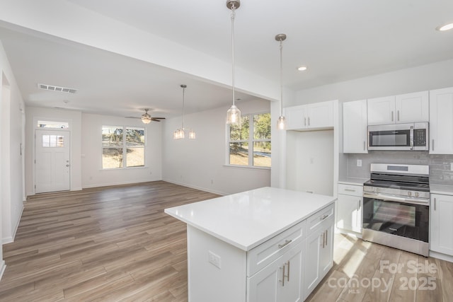 318 Sixth St, Belmont, NC 28012 - kitchen with appliances with stainless steel finishes, healthy amount of natural light, light wood finished floors, white cabinets, and recessed lighting
