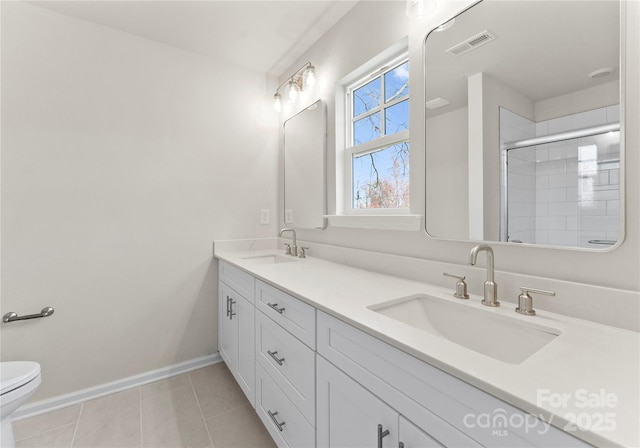 318 Sixth St, Belmont, NC 28012 - bathroom with double vanity, a tile shower, and tile patterned flooring