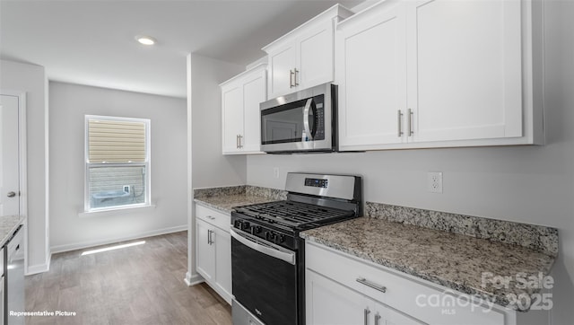 514 13th Avenue Dr NE, Hickory, NC 28601 - kitchen with stainless steel appliances, light wood-type flooring, white cabinetry, light stone countertops, and recessed lighting