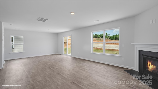 514 13th Avenue Dr NE, Hickory, NC 28601 - unfurnished living room with a glass covered fireplace, wood finished floors, and recessed lighting