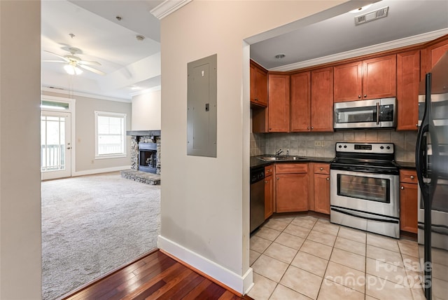9 Kenilworth Knl, Asheville, NC 28805 - kitchen with stainless steel appliances, electric panel, ornamental molding, ceiling fan, and light colored carpet