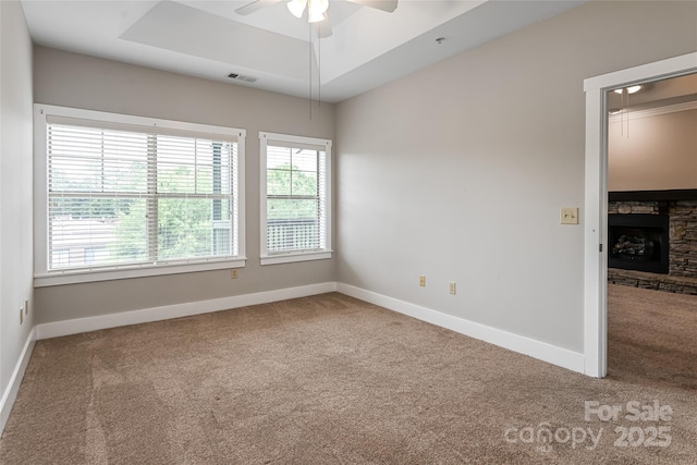 9 Kenilworth Knl, Asheville, NC 28805 - unfurnished room featuring carpet flooring, ceiling fan, a raised ceiling, and a fireplace