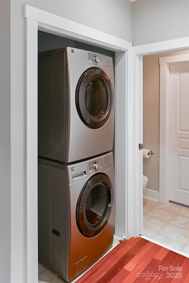 9 Kenilworth Knl, Asheville, NC 28805 - laundry area with stacked washing machine and dryer and light tile patterned floors