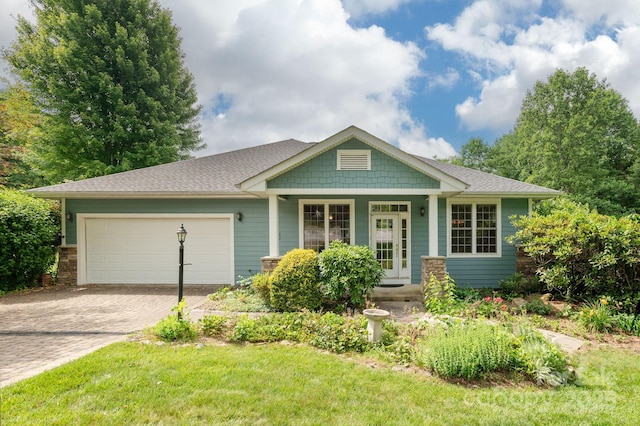 35 Stonecrest Ct, Flat Rock, NC 28731 - craftsman house featuring a garage, decorative driveway, a porch, a front lawn, and roof with shingles