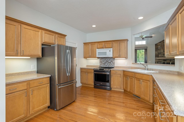 35 Stonecrest Ct, Flat Rock, NC 28731 - kitchen featuring appliances with stainless steel finishes, light wood-style floors, a ceiling fan, light countertops, and recessed lighting