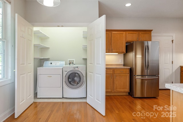35 Stonecrest Ct, Flat Rock, NC 28731 - laundry area featuring washing machine and dryer, plenty of natural light, light wood finished floors, and recessed lighting
