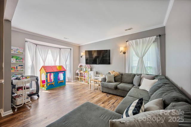 1045 Fairway Ridge Rd NW, Concord, NC 28027 - living room with crown molding, healthy amount of natural light, and wood finished floors