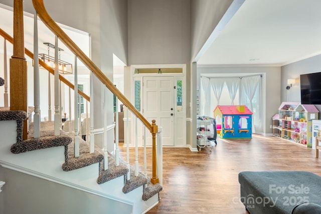 1045 Fairway Ridge Rd NW, Concord, NC 28027 - foyer with stairs, wood finished floors, a high ceiling, and crown molding