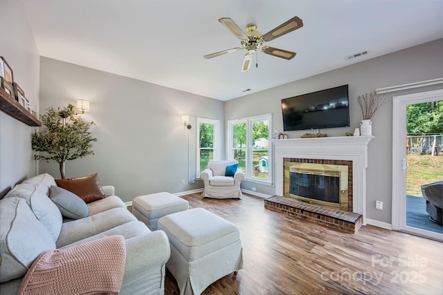 1045 Fairway Ridge Rd NW, Concord, NC 28027 - living room featuring wood finished floors, ceiling fan, and a brick fireplace
