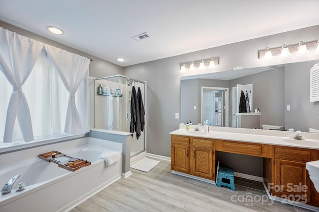 1045 Fairway Ridge Rd NW, Concord, NC 28027 - bathroom with a garden tub, a shower stall, double vanity, and recessed lighting