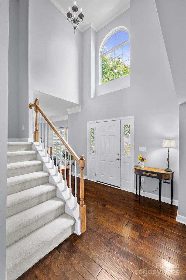 129 Nims Spring Dr, Fort Mill, SC 29715 - entryway featuring hardwood / wood-style flooring, stairway, a chandelier, a towering ceiling, and crown molding