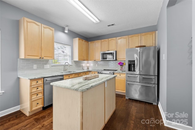 129 Nims Spring Dr, Fort Mill, SC 29715 - kitchen featuring appliances with stainless steel finishes, light brown cabinets, dark wood finished floors, and backsplash