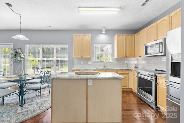 129 Nims Spring Dr, Fort Mill, SC 29715 - kitchen featuring light brown cabinets, stainless steel appliances, a kitchen island, dark wood finished floors, and a textured ceiling