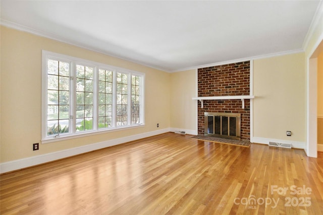 6921 Thermal Rd, Charlotte, NC 28211 - unfurnished living room with wood finished floors, ornamental molding, and a brick fireplace