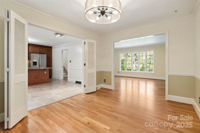 6921 Thermal Rd, Charlotte, NC 28211 - spare room featuring a chandelier, ornamental molding, light wood finished floors, and stairway