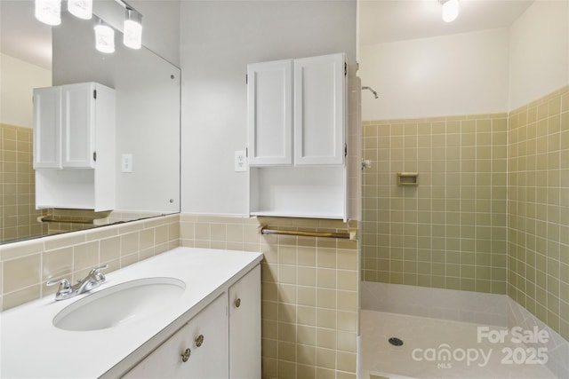 6921 Thermal Rd, Charlotte, NC 28211 - full bathroom with tile walls, tiled shower, vanity, and a wainscoted wall