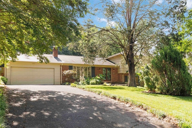6921 Thermal Rd, Charlotte, NC 28211 - view of front of property featuring brick siding, asphalt driveway, an attached garage, a front yard, and a chimney